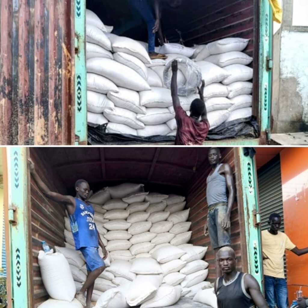 A group of men loading sacks into a truck