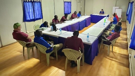 A group of leaders sitting at a meeting table