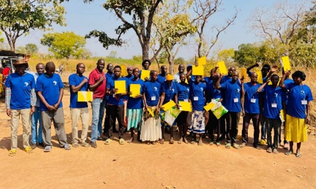 A group of people holding yellow signs