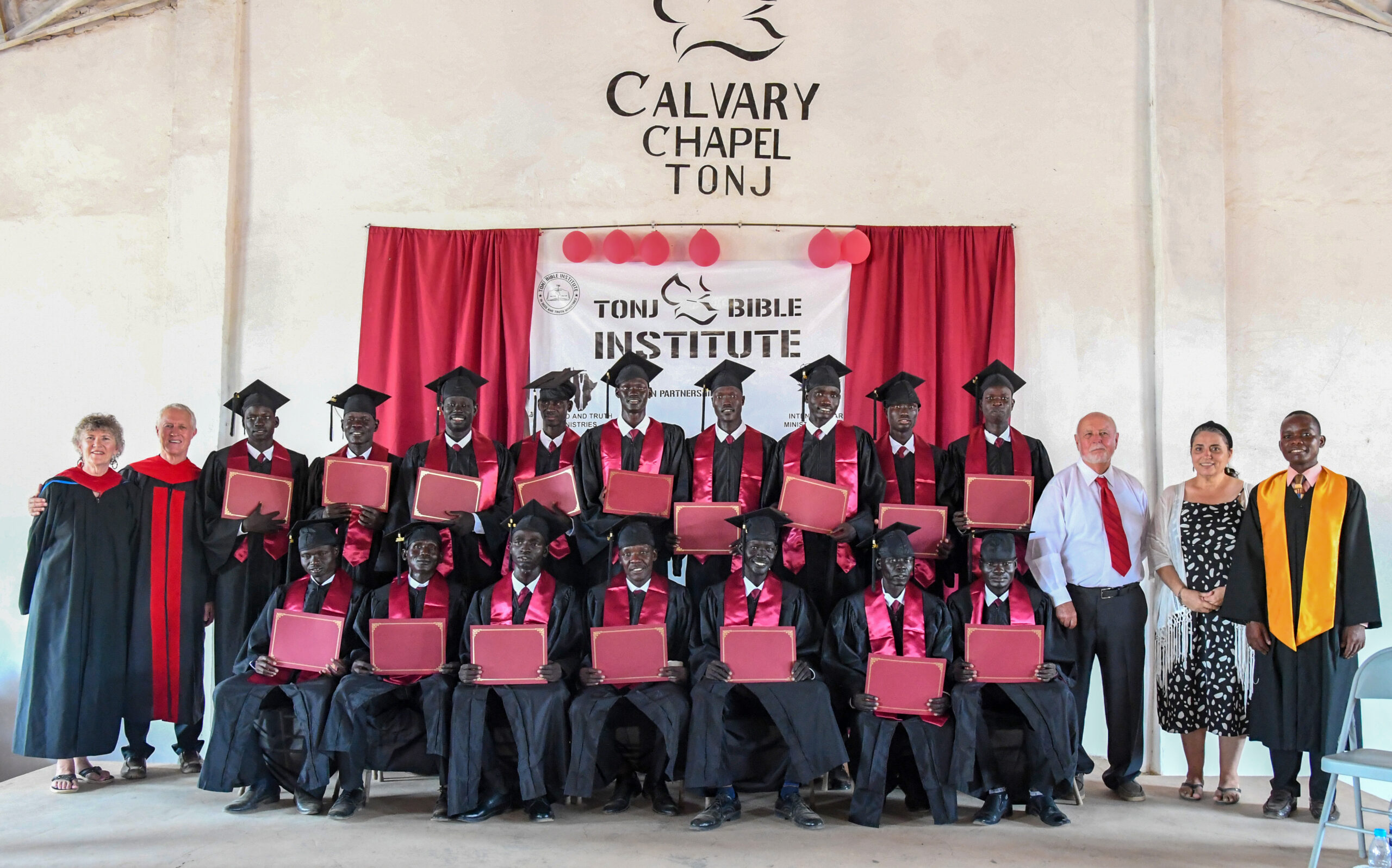 A group of people in graduation gowns and caps