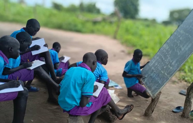 A group of children sitting on the ground