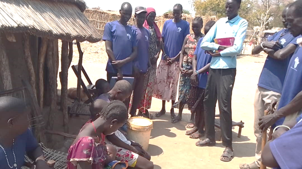 A group of people praying outside.